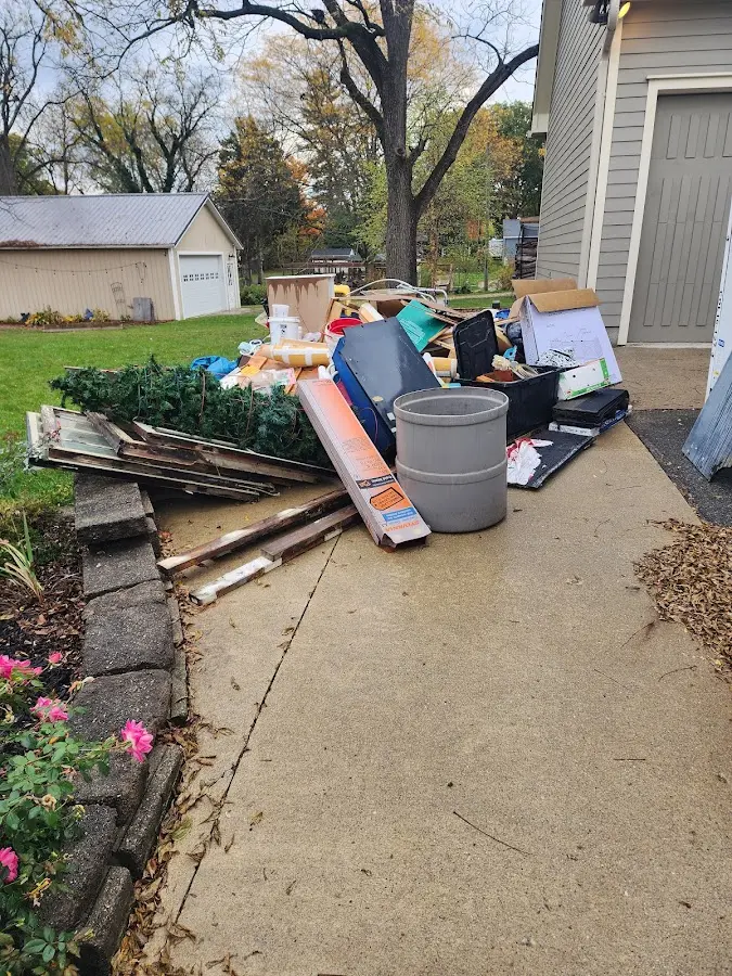 Dumpster being loaded with debris for Estate Cleanout Dumpster Rental in Sand Springs